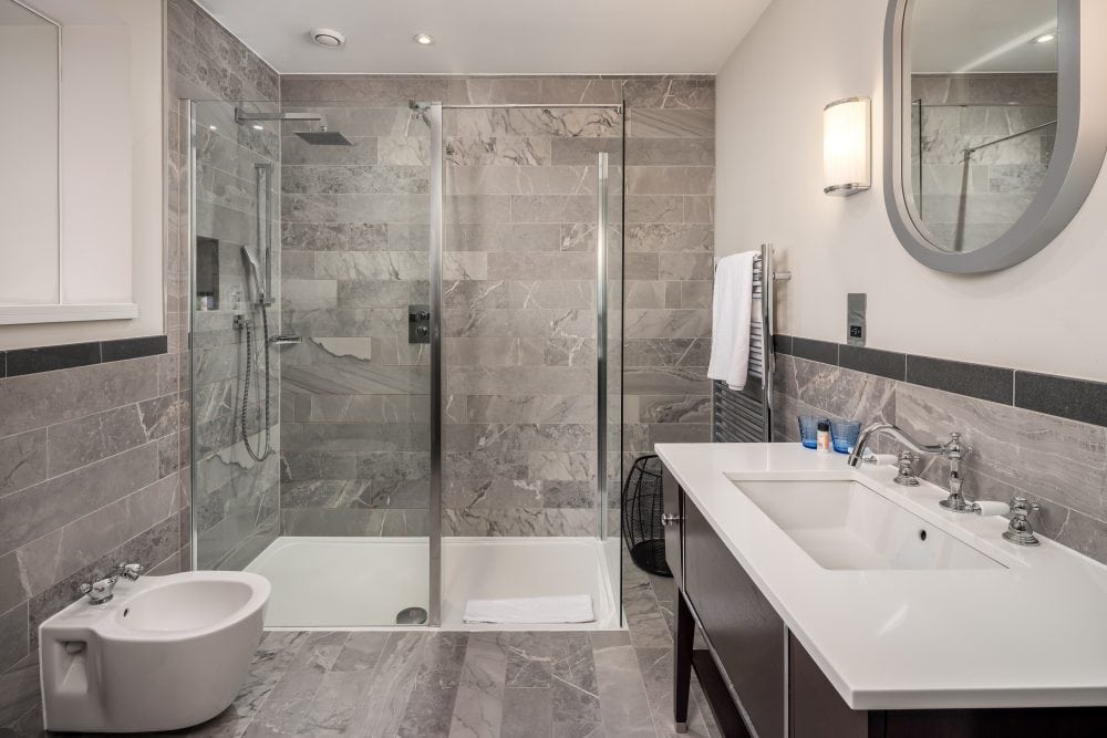 Hotel bathroom photography - a modern white and grey bathroom with shower in a five star hotel