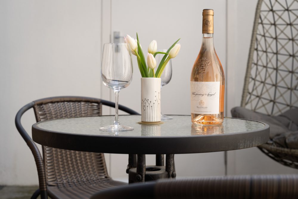 London AirBnB staged table with flowers and drinks