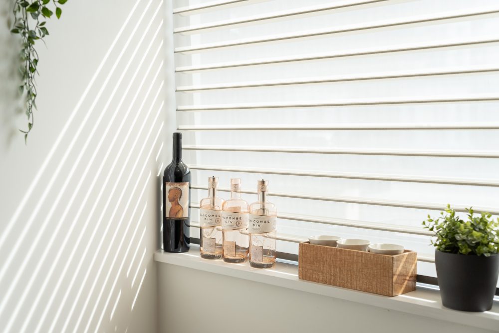 Bottles on a windowsill as light streams in through the window